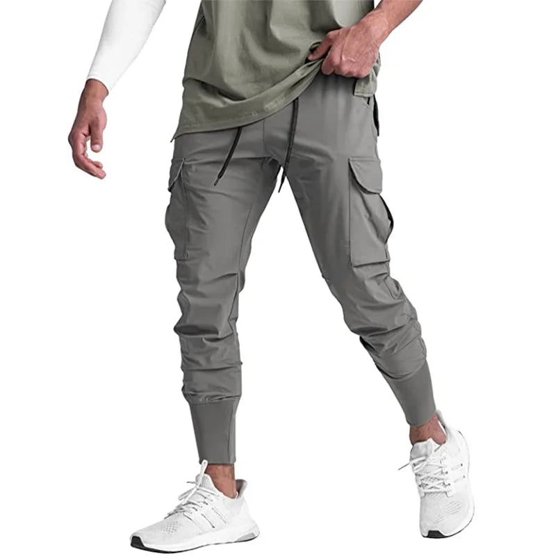 Nuevos pantalones deportivos de camuflaje para hombre, pantalones de fitness, pantalones de verano delgados, sueltos, de secado rápido, elásticos, pantalones de chándal para correr y entrenar.
