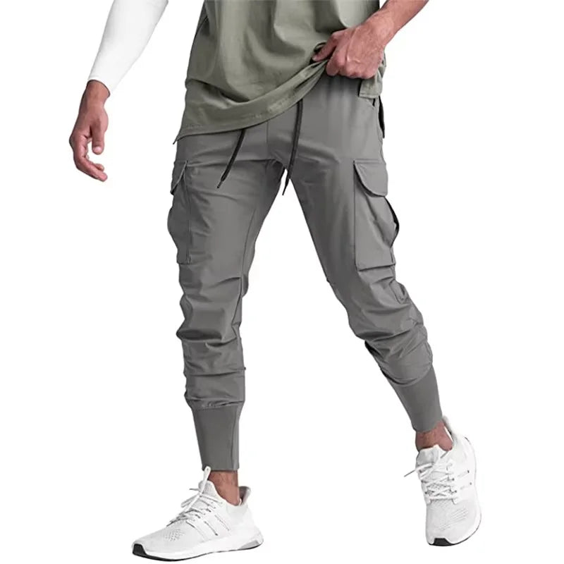 Nuevos pantalones deportivos de camuflaje para hombre, pantalones de fitness, pantalones de verano delgados, sueltos, de secado rápido, elásticos, pantalones de chándal para correr y entrenar.