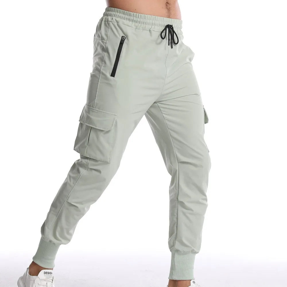 Nuevos pantalones deportivos de camuflaje para hombre, pantalones de fitness, pantalones de verano delgados, sueltos, de secado rápido, elásticos, pantalones de chándal para correr y entrenar.
